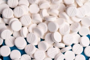 Blog Assorted prescription pills and capsules in a variety of colors and shapes on a white